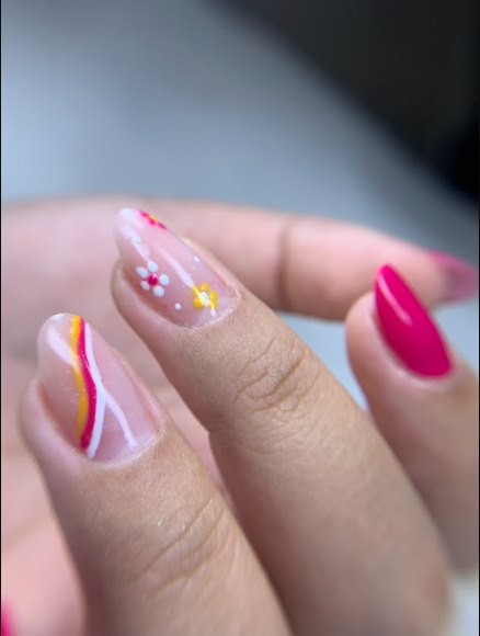 Nail art delicada com flores e linhas coloridas